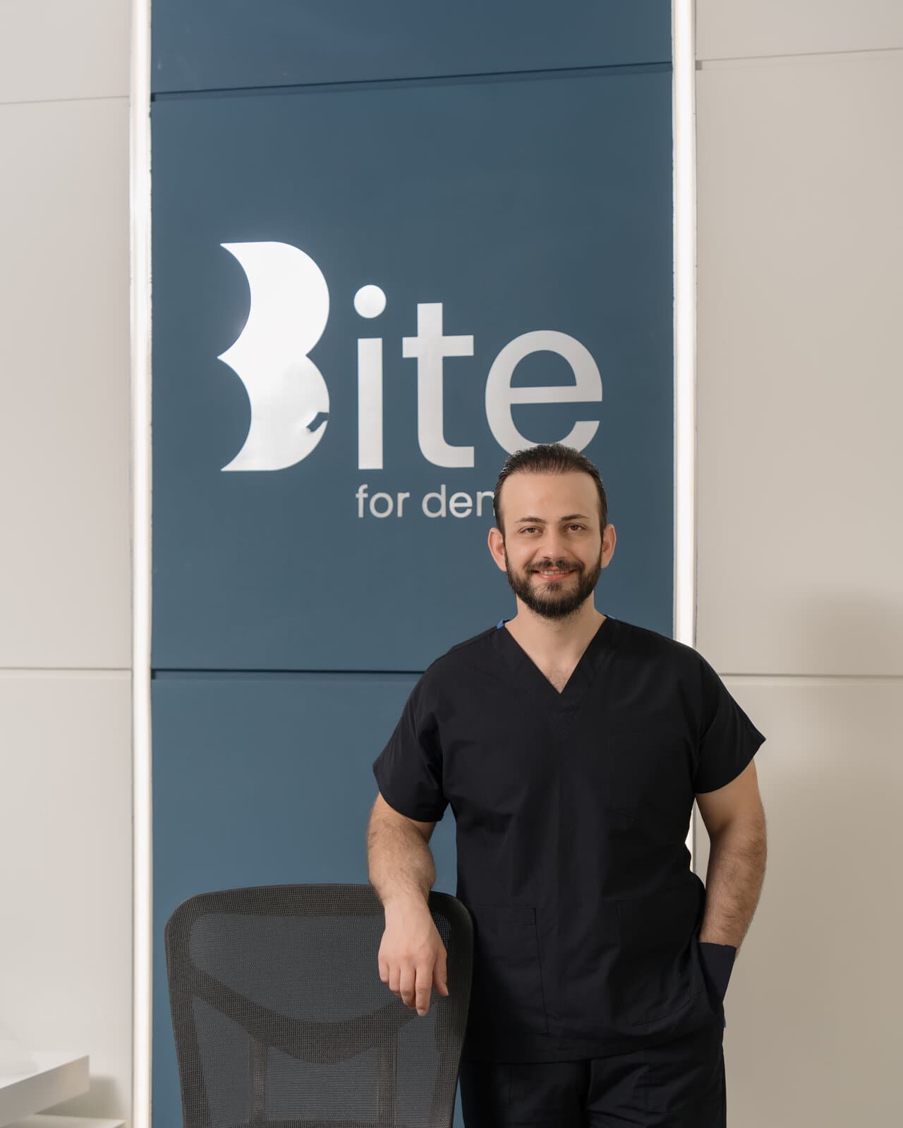 Dr. Jegr Koyi in scrubs at the Bite for Dentistry clinic